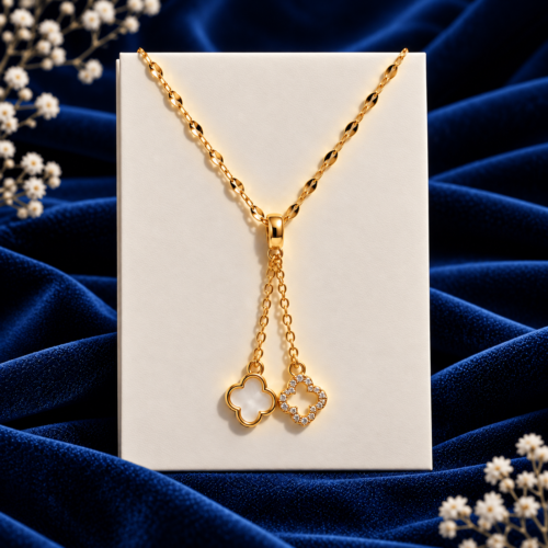 Golden Clover Necklace showing gold-tone links and twin clover charms on an ivory card against navy velvet