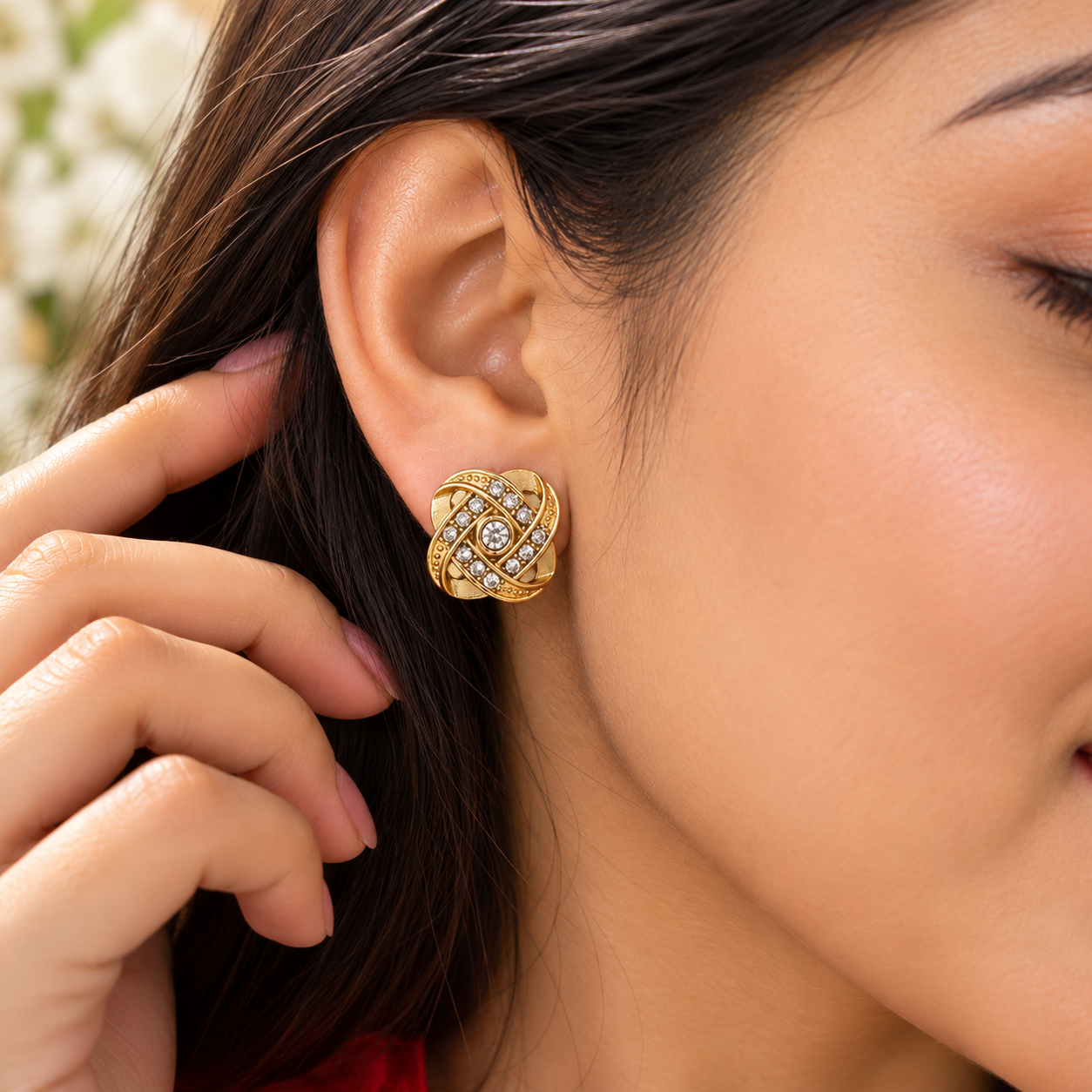 Golden Knot Earrings Worn by Woman Woman wearing gold-tone knot stud earrings