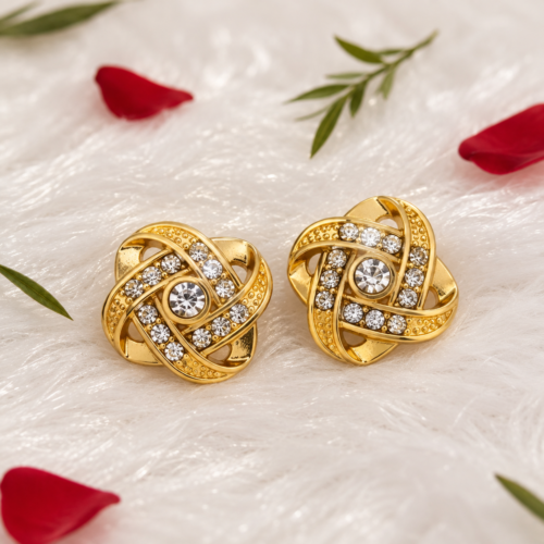 Pair of gold-tone knot stud earrings on plush fur