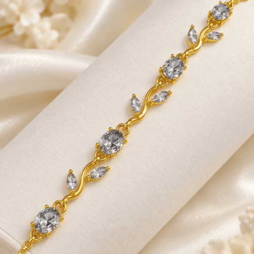Close-up of the gold-tone vine and clear stone details of a bracelet