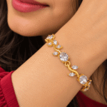 Woman wearing a gold-tone vine bracelet with clear oval and leaf-shaped stones