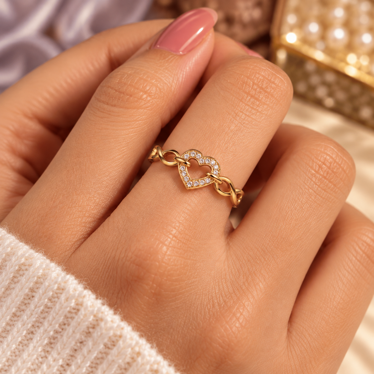 Infinity Heart Ring Worn on Finger Gold-tone open-heart ring with clear stones and infinity links worn on a finger