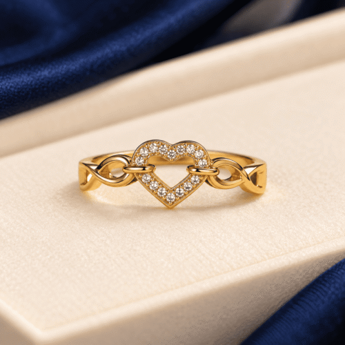 Front view of a gold-tone open-heart ring with clear stones and infinity side links on ivory velvet