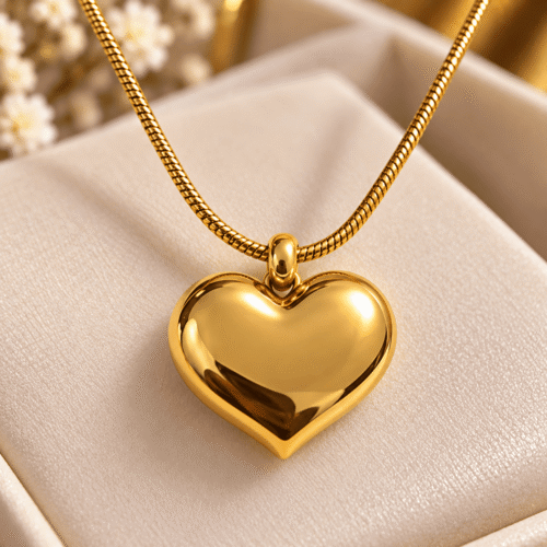Close-up of the smooth polished heart pendant and gold-tone chain of Lustrous Heart Necklace