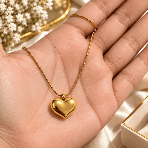 Lustrous Heart Necklace with a polished gold-tone heart pendant resting in an open palm