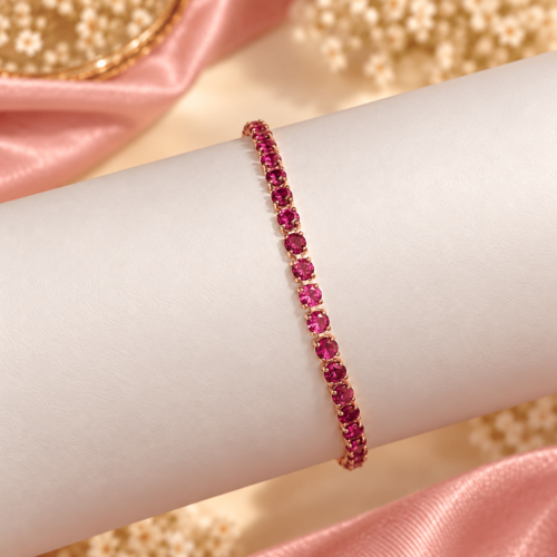 Magenta Glow Bracelet with round magenta-pink stones and rose gold-tone settings on an ivory display