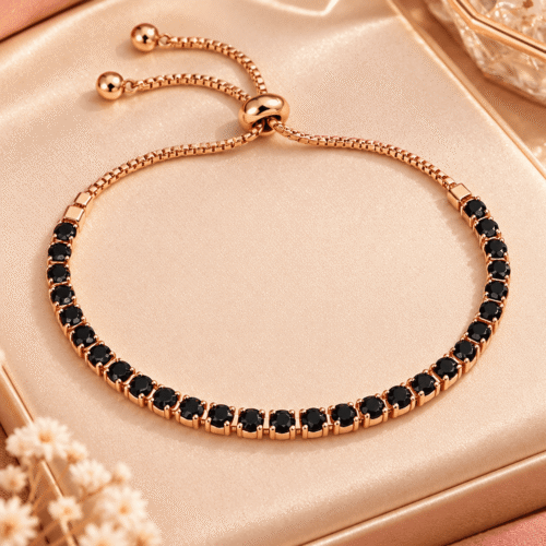 Full view of a rose gold-tone black stone bracelet with adjustable sliding closure