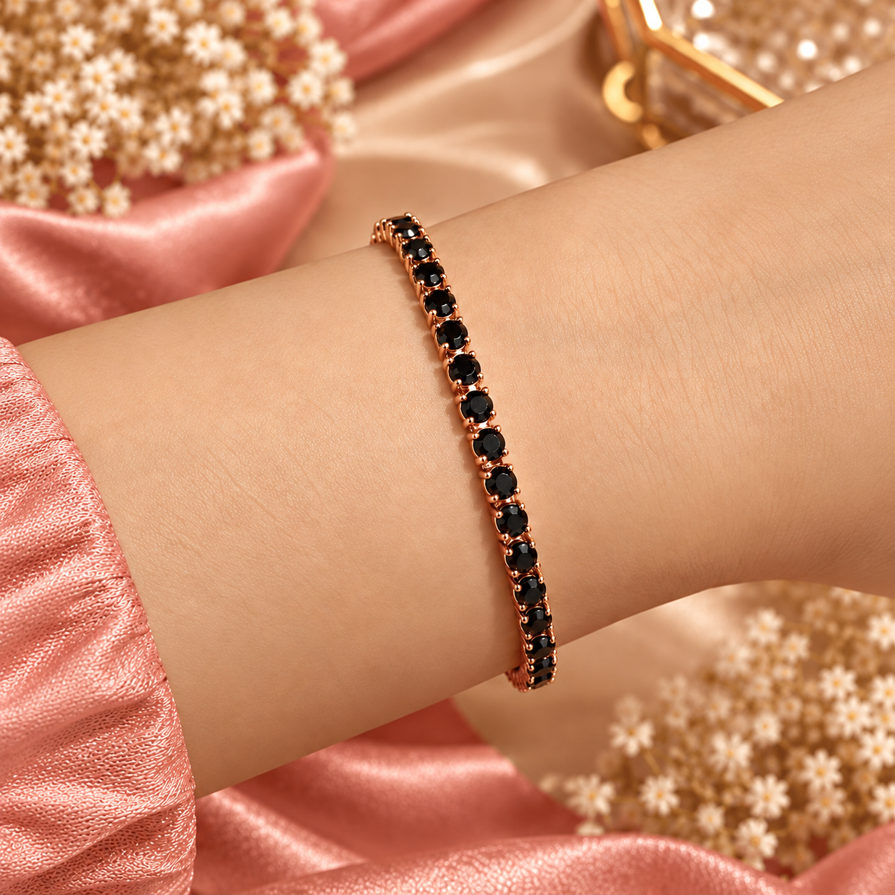 Midnight Glow Bracelet Worn on Wrist Rose gold-tone bracelet with round black stones worn on a wrist