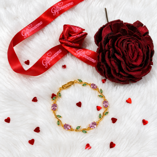 Pink and green stone bracelet displayed with GiftsNearMe ribbon and red decorative hearts