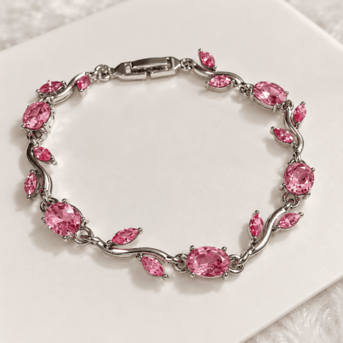 Complete pink vine bracelet with pink oval stones and silver-tone leaf details on ivory satin