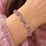 Pink vine bracelet with oval stones and silver-tone leaf details worn on a woman's wrist