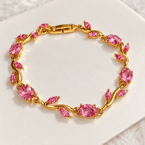 Full view of Rosy Vine Bracelet with pink oval stones and leaf-shaped accents on ivory satin