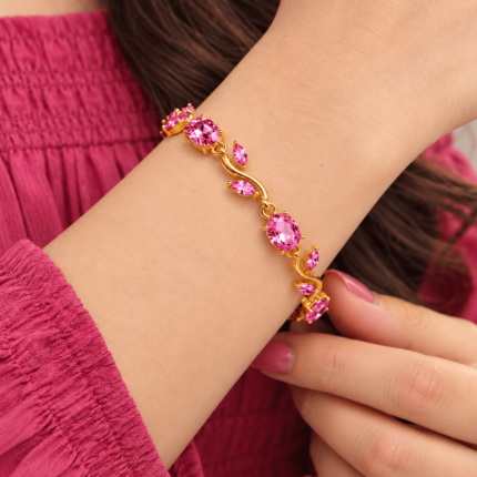 Rosy Vine Bracelet with pink stones and gold-tone vine links worn on a woman's wrist