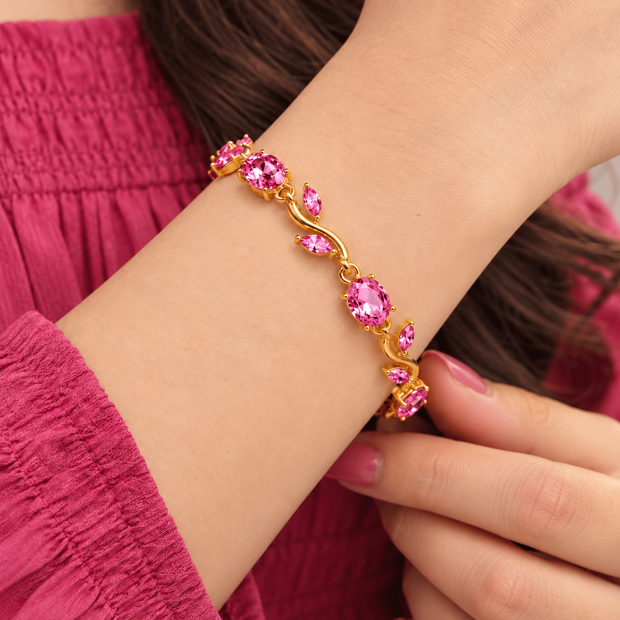 Rosy Vine Bracelet Worn on Wrist Square Rosy Vine Bracelet with pink stones and gold-tone vine links worn on a woman's wrist