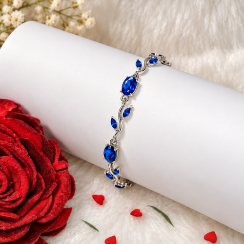 Blue stone vine bracelet displayed on a white jewellery cushion
