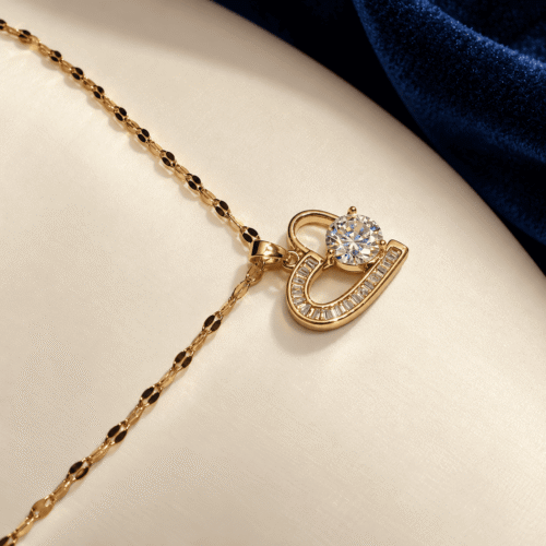 Close-up of the gold-tone open heart pendant with rectangular clear stones and a round center stone