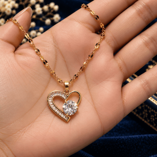 Sparkle Heart Necklace with gold-tone links and a clear-stone heart pendant resting in an open palm