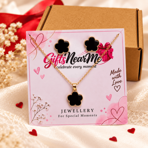 Close-up of Black Clover Jewellery Set necklace and matching stud earrings on a Gifts Near Me display card