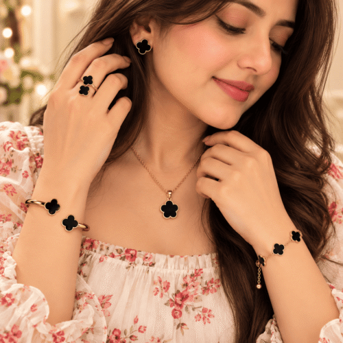 Woman wearing the Black Clover Jewellery Set with matching gold-tone necklace, earrings, ring and bracelets